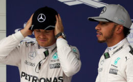 Mercedes’ Lewis Hamilton of Britain (R) stands next to Mercedes’ Nico Rosberg of Germany at the Brazilian Grand Prix. (REUTERS/Paulo Whitaker)