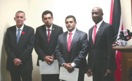 President Anthony Carmona, left, and Prime Minister Keith Rowley, right, with newly-appointed Cabinet Ministers Kazim Hosein, second from left, and Rohan Sinanan, after the swearing-in ceremony, yesterday.