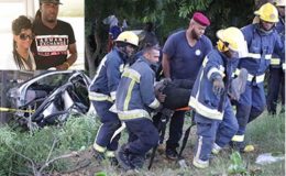 Fire officers remove one of the injured men from the wreckage along the Uriah Butler Highway near Biljah Road, Chaguanas, yesterday. Inset: Driver Kevin Frederick and his girlfriend Britney Balroop who were killed in the collision.