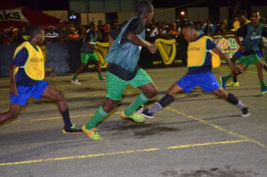 Crunching Challenge- Broad Street Bullies Rocky Gravesande (2nd from right) thwarting a Howes Street-A offensive move with a hard tackle at the Demerara Park in Guinness ‘Greatest of the Streets’ Georgetown Zone