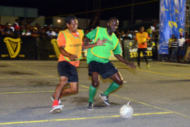 Eyes on the Ball - Phillip Rowley (right) of West Back Road shielding the ball away from an Albouystown-B player in their matchup in the Guinness ‘Greatest of the Streets’ Georgetown Zone at the Demerara Park. (Orlando Charles photo)