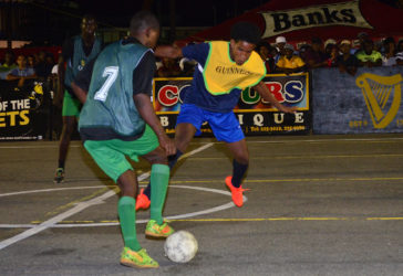 Devon Johnson (right) of Broad Street Bullies battling with a Howes Street player for possession of the ball during his team’s 3-0 victory at the Demerara Park in the Guinness ‘Greatest of the Streets’ Georgetown Zone. (Orlando Charles photo)