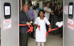 Minister of Public Health Dr George Norton assists Nurse Dublin of the Cardiac Intensive Care Unit to cut the ribbon commissioning the new unit. (Photo by Keno George)