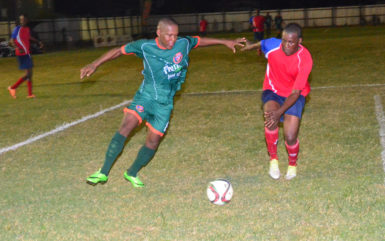 Goal scorer Jermin Junior (left) of Fruta Conquerors preparing to evade a challenge from his Monedderlust FC marker during his side’s 4-0 win at the Tucville ground in the GFF Stag Beer Elite League (Orlando Charles photo)
