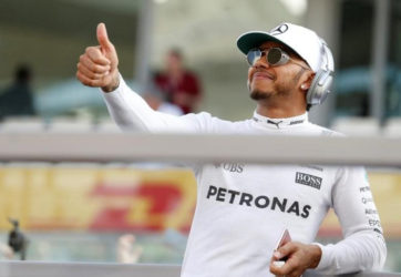 Mercedes’ Formula One driver, Lewis Hamilton of Britain gives thumbs up at his fans during driver’s parade. REUTERS/Hamad I Mohammed