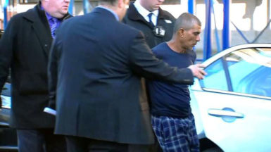 Prem Rampersaud as he was being placed in a police car. (ABC7 Eyewitness News photo) 