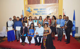 Winners of the Pan American Health Organisation/World Health Organisation (PAHO/WHO) Media Awards for Excellence in Health Journalism pose with PAHO/WHO Country Representative Dr William Adu-Krow (seated, left), Prime Minister Moses Nagamootoo (seated, second right) and Minister of Telecommunications Cathy Hughes (seated, right).