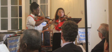 Two musicians from the Clemsville Music Ensemble entertain the gathering with a violin performance.