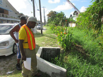 MPI’s Community Coordinator, Neilson McKenzie (foreground), inspects the Lamaha Street Canal during a recent walkabout of Newtown, Kitty. 