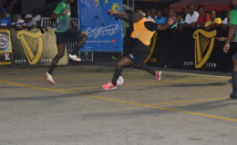 Stellon David (left) of Bent Street attempting a tackle on Wendell Austin (right) of Camp Street All-Stars at the Demerara Park in the Guinness ‘Greatest of the Streets’ Football Championship