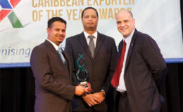 In photo: Nand Persaud International Communication Inc Managing Director Gadhram Ramdial (left) displays the trophy presented to the company along with Chief Executive Officer of GO-Invest  and Caribbean Export Board Member  for Guyana Owen Verwey (centre) and Deputy Executive Director, Caribbean Export Escipion Oliveira.