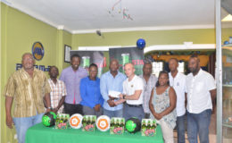 Brand Manager Robert Hiscock (fifth from right) handing over the sponsorship cheque to East Bank Football Association President and tourney coordinator Franklin Wilson at the launch of the Stag Nations Cup in the presence of members of the other competing associations and GFF third Vice President Thandi McCallister (fourth from left)
