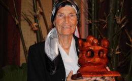 The late Diane McTurk displaying the Caribbean Excellence in Sustainable Tourism Award that was bestowed to the Karanambu Lodge in 2013.  (Karanambu Lodge photo)
