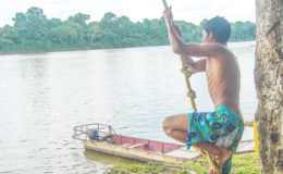 This young man prepares to swing out on a rope to take a dip on the Essequibo River(Photo by Mariah  Lall)