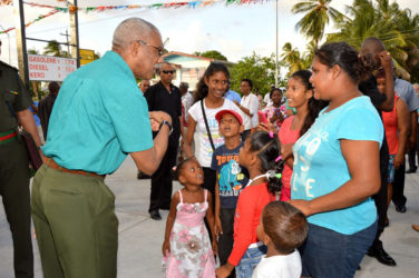 President David Granger (left) sharing a light moment with this family, who were present at the Buxton/ Friendship Gas Station and Plaza’s opening yesterday afternoon. (Ministry of the Presidency photo)