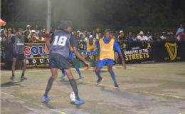 Amoniki Rodgers (no.18) of Camp Street All-Stars trying to initiate an attacking play while being guarded by Eusi Phillips (right) of Sparta Boss during their quarterfinal affair at Demerara Park in the Guinness ‘Greatest of the Streets’ Championship Saturday.