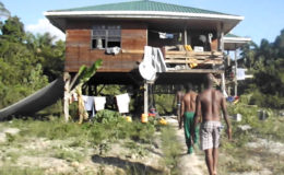 Police officers at Halley’s home with their clothing hanging on lines and strewn about the veranda.