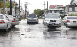 Vehicles had to be very cautious along the deeply flooded Quamina Street yesterday.