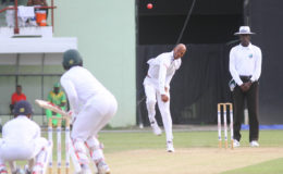 Roston Chase offers up a well flighted off break.
