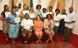 In photo sitting, left to right are course facilitator, Warrant Officer Weslyn Boodie, First Lady, Sandra Granger and Lt. Col. (ret’d)  Yvonne Smith with the staff of State House (Ministry of the Presidency photo).