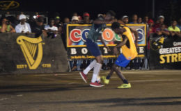 50/50-Tucville’s Dennis Edwards (left) and Broad Street’s Daren Benjamin (right) challenging for possession of the ball during their semi-final matchup at the National Cultural Centre tarmac in the Guinness ‘Greatest of the Streets’ Championship
