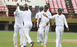 HIGH FIVE TIME! The Guyana Jaguars can now go to the Christmas break on a high after their 10-wicket triumph over the Trinidad Red Force team yesterday. (Orlando Charles photo)