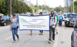 Representatives of the Transparency Institute of Guyana (TIGI) marching along Main Street in commemoration of World Anti-Corruption Day. (Photo by Keno George)