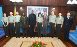 In this Ministry of the Presidency photo, with the military delegation are President David Granger (fifth from left)  and Chief of Staff of the Guyana Defence Force  Brigadier George A Lewis, (fourth from left). Also in photo is Counsellor Yang Chenqi of the Chinese Embassy (fourth from right).