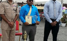 Overall Best Cop Detective Corporal Prem Narine (centre) poses with his prizes with Commissioner Seelall Persaud (left) and Crime Chief Wendell Blanhum at the conclusion of the award ceremony.