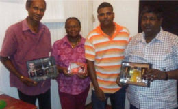 From left, Paul D’Anjou, Marilyn Ali, Khemraj Pooranmall and Jairam display their prizes following last Saturday’s AGM and awards
ceremony of the Guyana Draughts association.