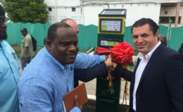 From left: Town Clerk Royston King, SCS Global Head of Operations Simon Mosheshvili (partly hidden) and Smart City Solutions Global Head of Business Development Amir Oren cutting the ribbon on the first parking meter outside City Hall on Regent Street yesterday.