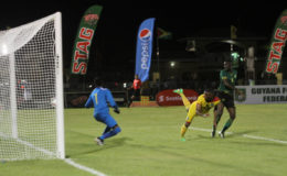 Flashblack:Adrian Butters of Guyana (yellow) in the process of scoring his team’s second goal with a header during their match against Jamaica in the CFU Caribbean Cup Qualifiers at the National Track and Field Centre in Leonora. (Orlando Charles photo)