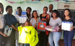 Christopher Barnwell and group with Administrator Roxanne Blenman and staff with the donation.