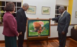 President David Granger (left)  presenting to Barbadian Prime Minister Freundel Stuart a painting done by Guyanese artist Merlene Ellis for the people of Barbados on the occasion of their 50th Anniversary of Independence.  The painting is of Guyana’s national bird the Canje Pheasant. The President and First Lady Sandra Granger were guests of Barbados for the celebrations. (Ministry of the Presidency photo)