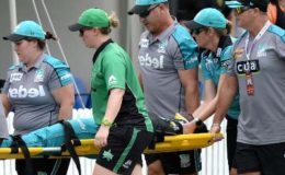Deandra Dottin being stretchered away by team and WBBL medical personnel after a collision with Brisbane Heat teammate Laura Harris.