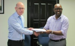In this MPI photo, DHBC General Manager, Rawlston Adams (right) and Arie Mol of LievenseCSO (left) shake hands following the signing of the contract.