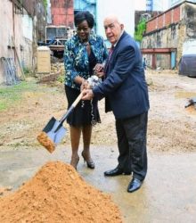 Minister of Planning and Development Camille Robinson-Regis and Issa Nicholas, chairman of Nicholas Group of Companies, turn the sod during yesterday’s ceremony for a new multi-storey car park at Chacon Street, Port of Spain.