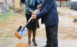 Minister of Planning and Development Camille Robinson-Regis and Issa Nicholas, chairman of Nicholas Group of Companies, turn the sod during yesterday’s ceremony for a new multi-storey car park at Chacon Street, Port of Spain.
