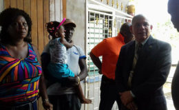 Minister of Public Health, Dr George Norton (right) with the parents and child of Lonette Nicholson-Prince