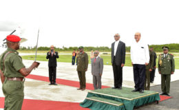 President David Granger (left) and President Désiré Delano Bouterse being accorded the Guard of Honour Salute at the Eugene F. Correia International Airport. (Ministry of the Presidency photo) 
