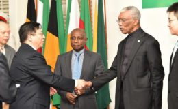 President David Granger (second from right) and newly accredited Chinese Ambassador to Guyana, Cui Jianchun exchange a handshake as acting Prime Minister and Minister of Foreign Affairs, Carl Greenidge (centre) looks on. (Ministry of the Presidency photo) 
