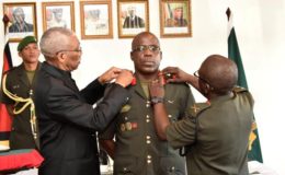 In this Ministry of the Presidency photo,  President Granger (left) and former Chief of Staff, Brigadier George Lewis decorating Brigadier Patrick West with his new badge of rank at Base Camp Ayanganna.