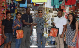 Trophy Stall proprietor Ramesh Sunich (third right) hands over the winning trophy and nets to Petra Organisation member Mark Alleyne in the presence of Petra Organisation co-director Troy Mendonca and staffers yesterday.