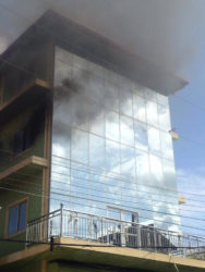 Thick smoke coming from the building shortly after the fire started. (Photo by Sharda Bacchus)