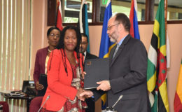 Deputy Representative at UN Women Tonni Ann Brodber and Secretary-General of Caricom Irwin LaRocque shake hands after the signing of the Memorandum of Understanding on Gender Equality and the Empowerment of Women (See story on page 3) (Government Information Agency photo)