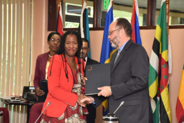 Deputy Representative at UN Women Tonni Ann Brodber and Secretary-General of Caricom Irwin LaRocque shake hands after the signing of the Memorandum of Understanding on Gender Equality and the Empowerment of Women (See story on page 3) (Government Information Agency photo)