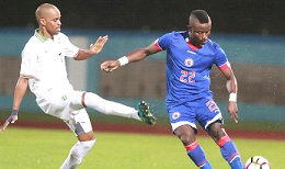 Haiti’s Alex Christian (right) looks to make a pass against Suriname during their CFU Men’s Caribbean Cup fifth-place playoff match on January 6  (CONCACAF/CA-Images) 
