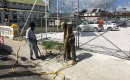 Mayor and City Council workers using a jackhammer to destroy the concrete erection on the pavement in front of the Teleperformance Parking Lot on Camp Street.
