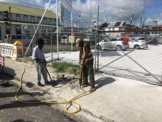 Mayor and City Council workers using a jackhammer to destroy the concrete erection on the pavement in front of the Teleperformance Parking Lot on Camp Street.
