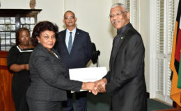 President David Granger  presenting retired judge Claudette Singh with her Commission of Appointment as Senior Counsel in 2017. (Ministry of the Presidency photo) 